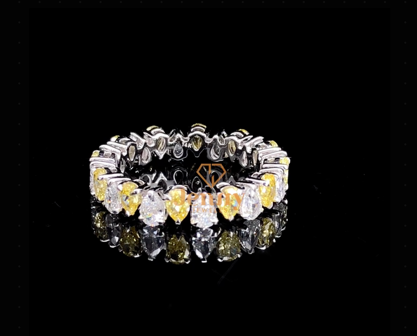Pear-shaped diamond eternity ring with a mix of white and fancy yellow diamonds, set in white, yellow, or rose gold. A bold and elegant statement piece.