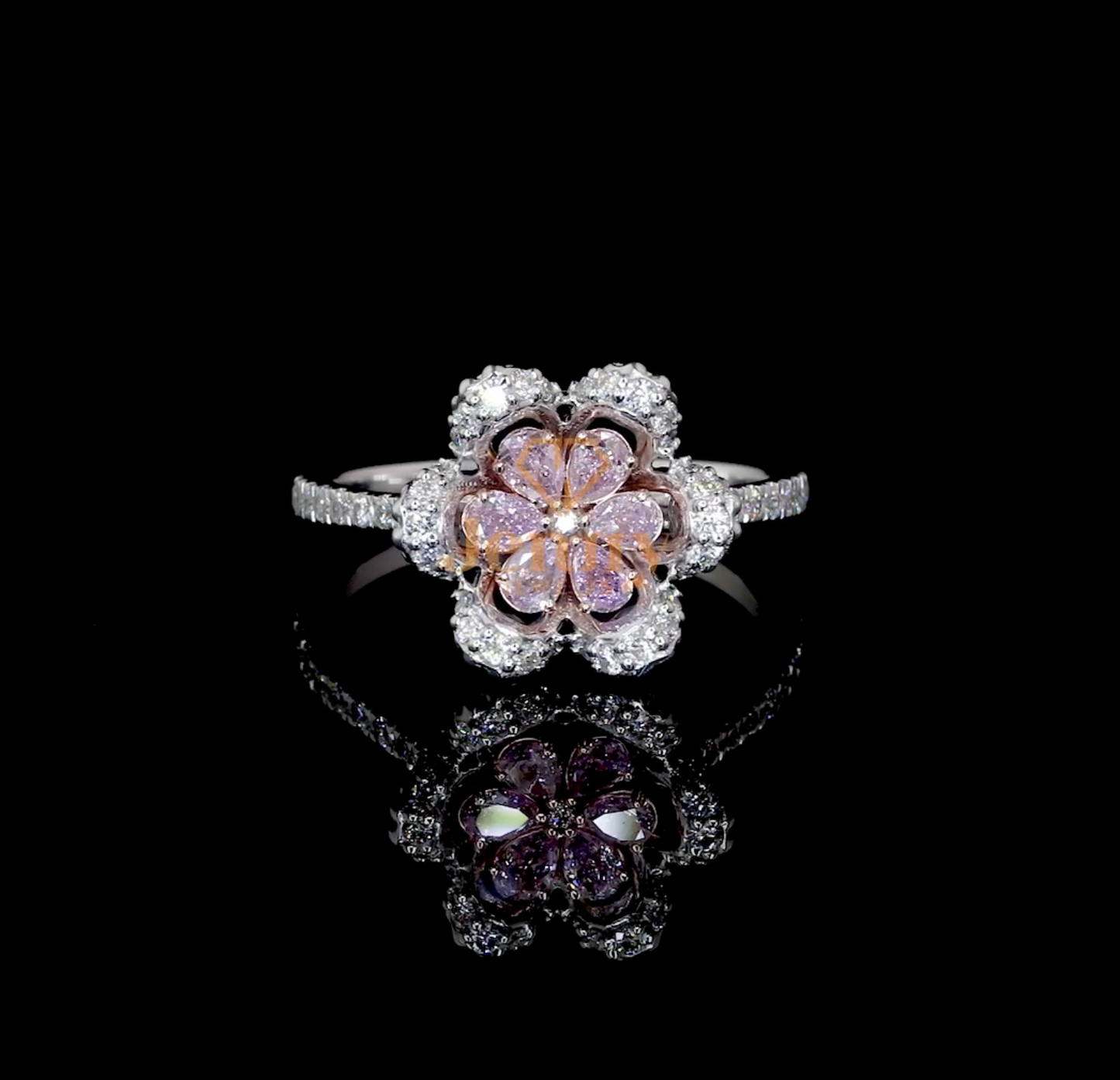 Floral-inspired ring featuring pink sapphires or pink diamonds, accent diamonds in pear and round cuts, and a premium gold band available in white, yellow, or rose gold.