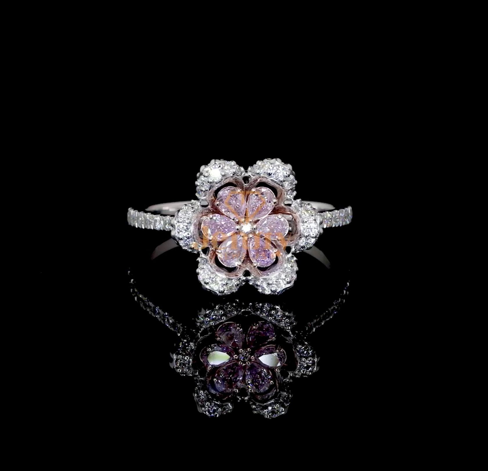 Floral-inspired ring featuring pink sapphires or pink diamonds, accent diamonds in pear and round cuts, and a premium gold band available in white, yellow, or rose gold.