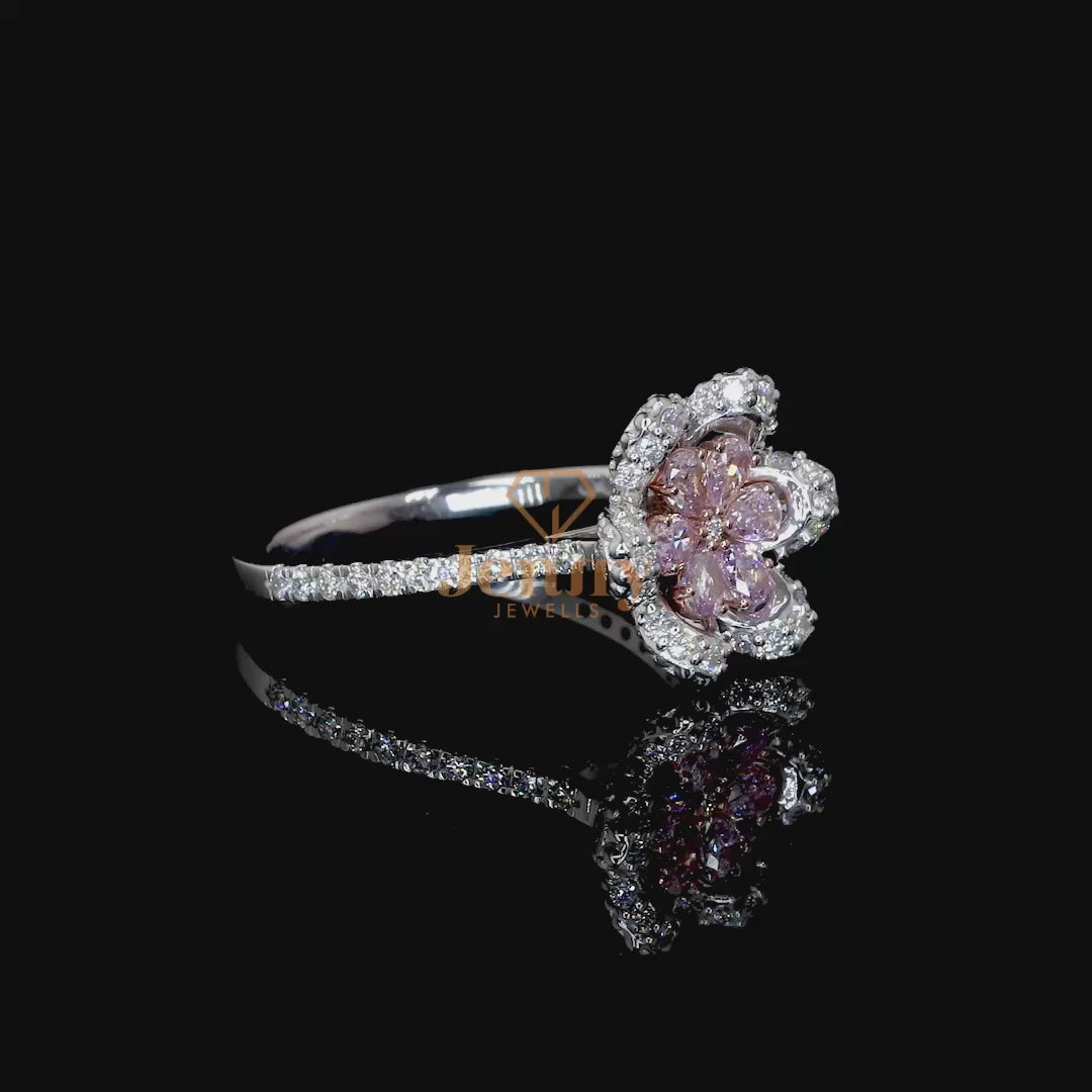 Floral-inspired ring featuring pink sapphires or pink diamonds, accent diamonds in pear and round cuts, and a premium gold band available in white, yellow, or rose gold.